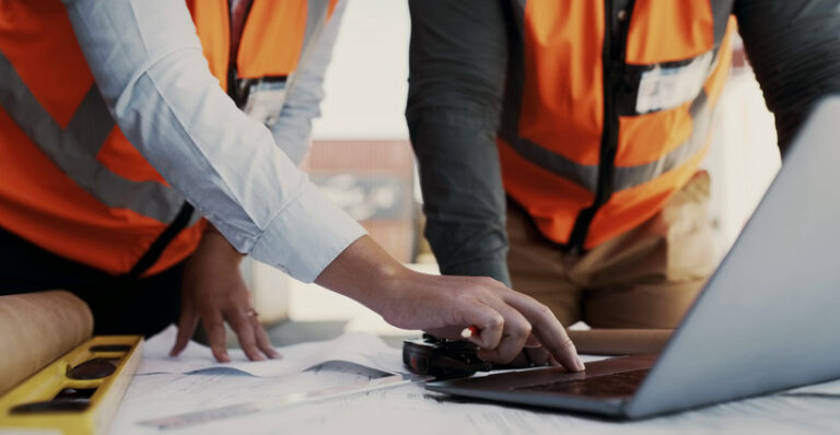 site contractor inspecting design plans